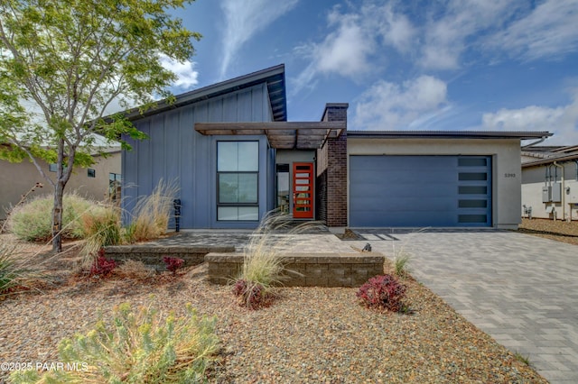 5393 Crescent Edge Dr, Prescott, AZ 86301 - modern home featuring a garage, board and batten siding, and decorative driveway