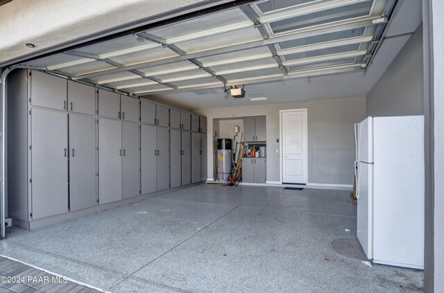 5393 Crescent Edge Dr, Prescott, AZ 86301 - garage with freestanding refrigerator, water heater, a garage door opener, and baseboards