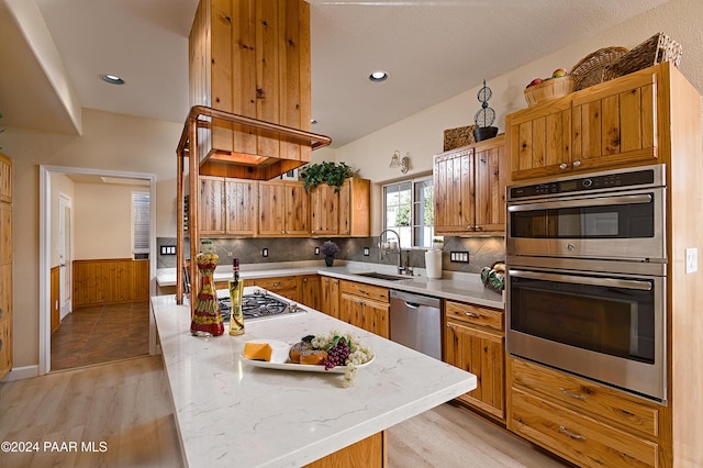 4860 W Stazenski Rd, Prescott, AZ 86305 - kitchen with a sink, a center island, stainless steel appliances, light wood-type flooring, and tasteful backsplash