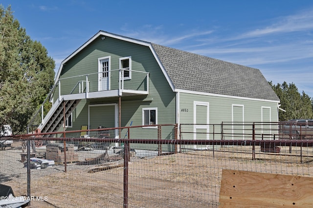 4860 W Stazenski Rd, Prescott, AZ 86305 - back of house featuring roof with shingles, fence, stairs, and a gambrel roof