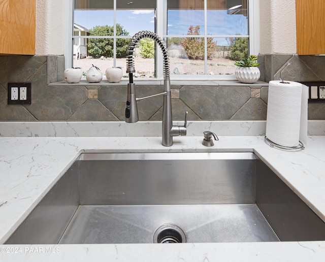 4860 W Stazenski Rd, Prescott, AZ 86305 - interior details featuring light stone countertops, decorative backsplash, and a sink