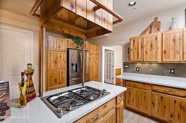 4860 W Stazenski Rd, Prescott, AZ 86305 - kitchen with backsplash, stainless steel appliances, light stone counters, and light wood-type flooring