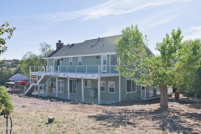 4860 W Stazenski Rd, Prescott, AZ 86305 - back of property with a gazebo, a wooden deck, stairway, a chimney, and a patio area