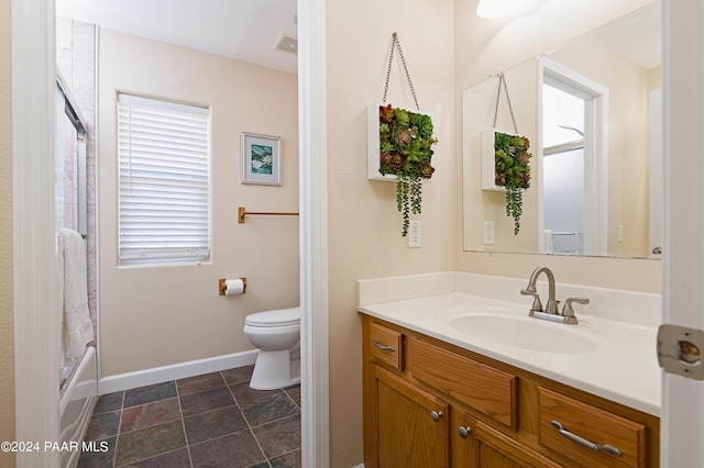 4860 W Stazenski Rd, Prescott, AZ 86305 - bathroom featuring vanity, toilet, baseboards, stone finish flooring, and visible vents