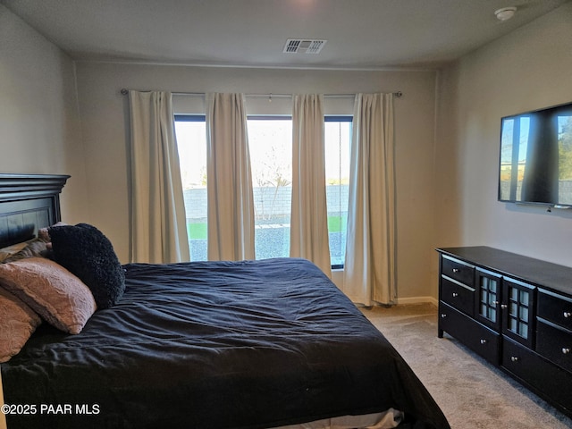 bedroom with light colored carpet