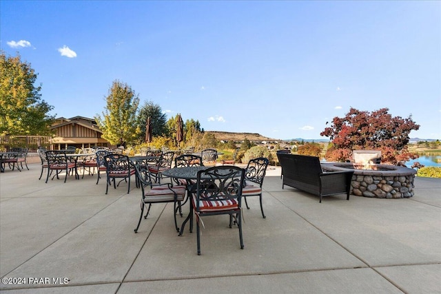 view of patio / terrace with a water view and a fire pit