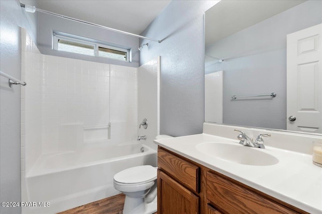 full bathroom with hardwood / wood-style flooring, vanity, toilet, and shower / bathing tub combination