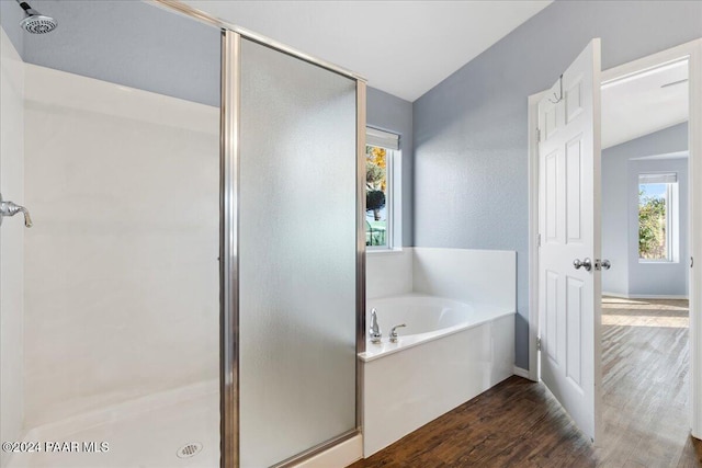 bathroom featuring hardwood / wood-style flooring, a healthy amount of sunlight, lofted ceiling, and independent shower and bath