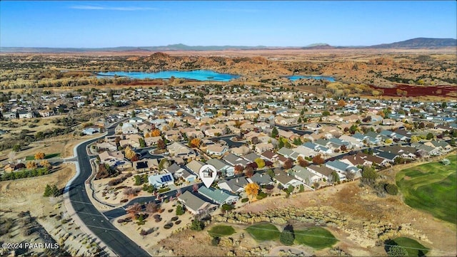 drone / aerial view with a water and mountain view