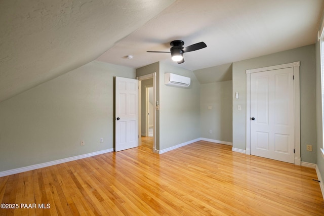 213 N Virginia St, Prescott, AZ 86301 - additional living space featuring a wall mounted AC, vaulted ceiling, a ceiling fan, light wood-type flooring, and baseboards