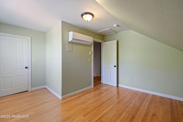 213 N Virginia St, Prescott, AZ 86301 - bonus room featuring an AC wall unit, attic access, light wood-type flooring, baseboards, and vaulted ceiling