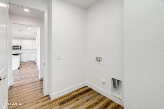 clothes washing area with electric dryer hookup, hookup for a gas dryer, light hardwood / wood-style floors, and hookup for a washing machine