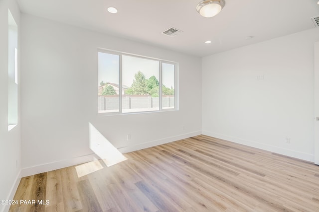 empty room with light hardwood / wood-style flooring