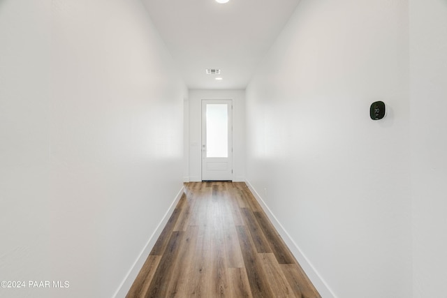 hallway with hardwood / wood-style floors