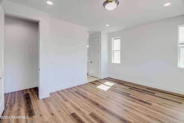 unfurnished bedroom with a closet and light hardwood / wood-style flooring