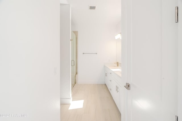 bathroom featuring vanity and an enclosed shower