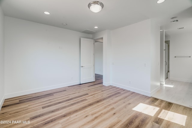 empty room with light hardwood / wood-style floors