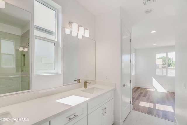 bathroom with vanity, an enclosed shower, and wood-type flooring