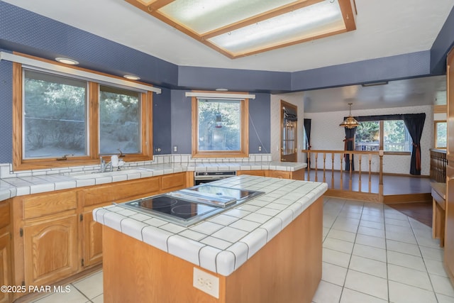 1104 Country Club Dr, Prescott, AZ 86303 - kitchen with tile countertops, light tile patterned flooring, black electric cooktop, a sink, and wallpapered walls