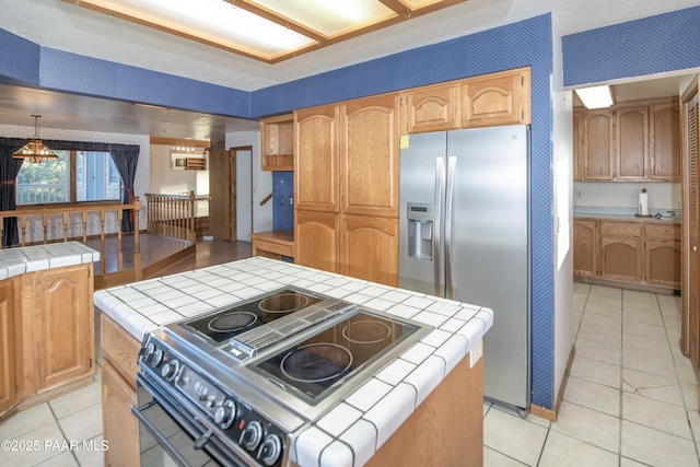 1104 Country Club Dr, Prescott, AZ 86303 - kitchen featuring stainless steel refrigerator with ice dispenser, tile counters, range with electric cooktop, light tile patterned flooring, and wallpapered walls