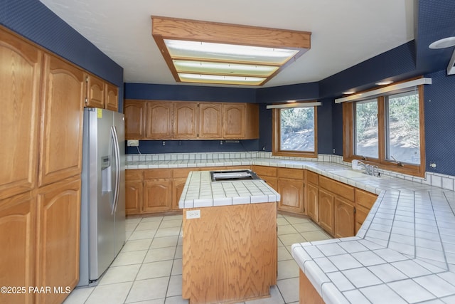 1104 Country Club Dr, Prescott, AZ 86303 - kitchen featuring appliances with stainless steel finishes, tile countertops, a sink, a center island, and light tile patterned floors