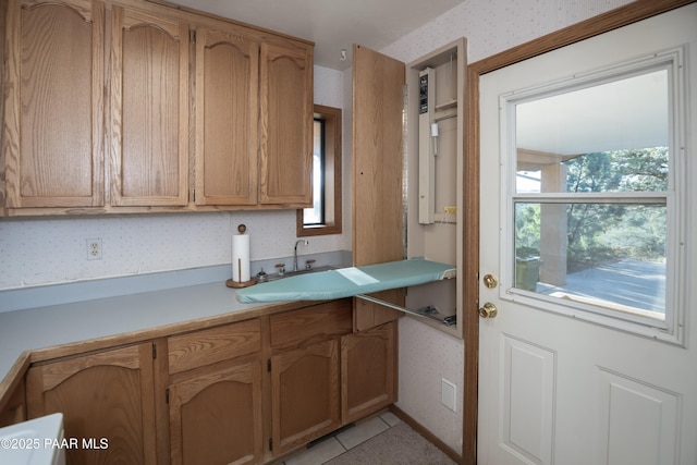 1104 Country Club Dr, Prescott, AZ 86303 - kitchen with wallpapered walls, light countertops, a sink, and light tile patterned flooring