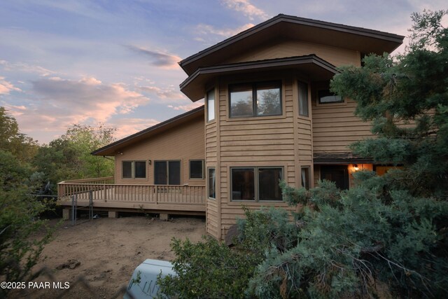 1104 Country Club Dr, Prescott, AZ 86303 - back of property at dusk with a deck