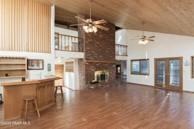 1104 Country Club Dr, Prescott, AZ 86303 - living room featuring ceiling fan, high vaulted ceiling, wood finished floors, a fireplace, and wood ceiling