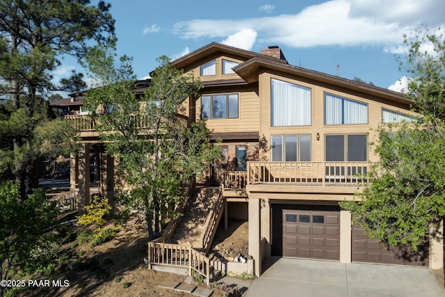 1104 Country Club Dr, Prescott, AZ 86303 - back of property featuring driveway, a chimney, an attached garage, and stairs