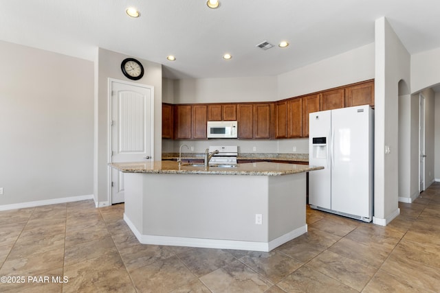 4726 N Salem Pl, Prescott Valley, AZ 86314 - kitchen featuring white appliances, a kitchen island with sink, light stone countertops, recessed lighting, and baseboards