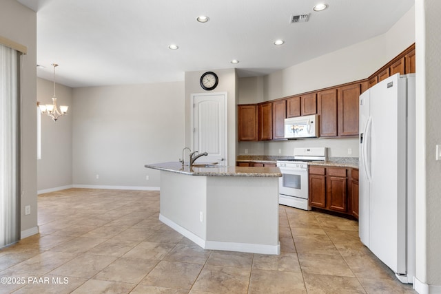 4726 N Salem Pl, Prescott Valley, AZ 86314 - kitchen featuring white appliances, a kitchen island with sink, recessed lighting, a chandelier, and brown cabinets
