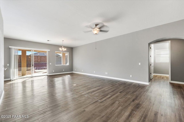 unfurnished room with dark wood-type flooring and ceiling fan with notable chandelier