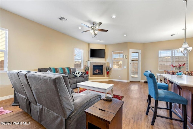 living room with ceiling fan and hardwood / wood-style floors