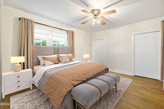 bedroom with light wood-type flooring, ceiling fan, and crown molding