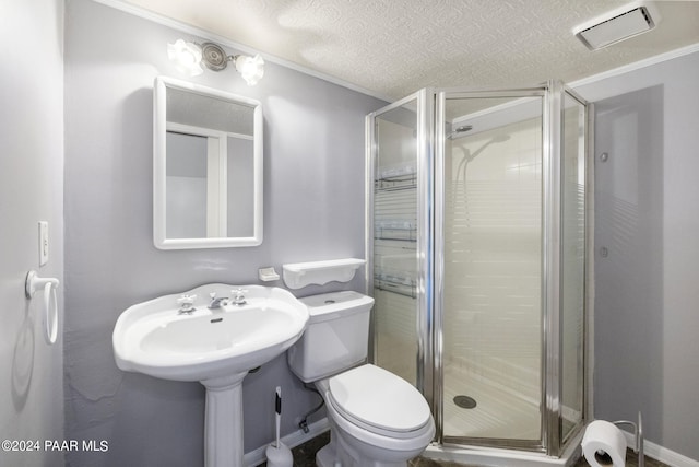 bathroom with sink, crown molding, toilet, a textured ceiling, and a shower with shower door