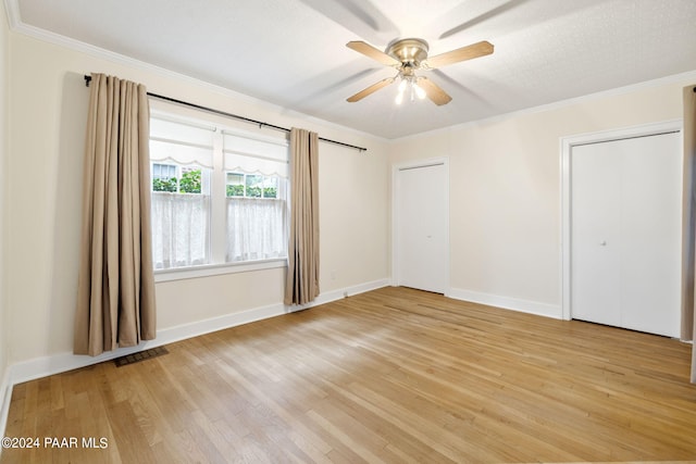 unfurnished bedroom with a textured ceiling, light wood-type flooring, ceiling fan, and crown molding