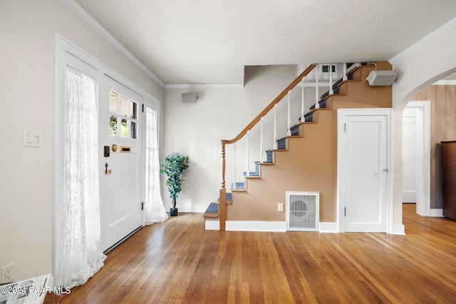 foyer featuring hardwood / wood-style floors and ornamental molding