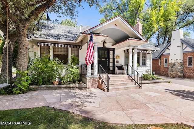 716 Country Club Dr, Prescott, AZ 86303 - view of front facade featuring a chimney, a porch, and roof with shingles