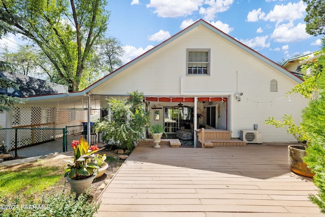 rear view of property featuring a wooden deck, ceiling fan, and ac unit