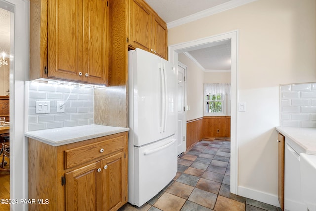 kitchen with white fridge, ornamental molding, and tasteful backsplash