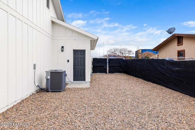 view of yard featuring central air condition unit and fence