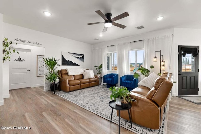 living area featuring recessed lighting, baseboards, light wood finished floors, ceiling fan, and visible vents