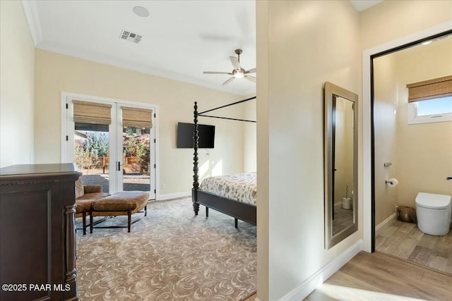 bedroom with access to exterior, ensuite bathroom, ornamental molding, light hardwood / wood-style floors, and french doors