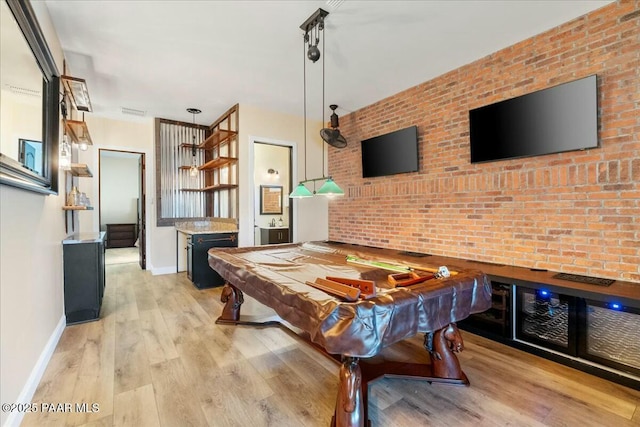 game room featuring billiards, brick wall, rail lighting, and light hardwood / wood-style floors