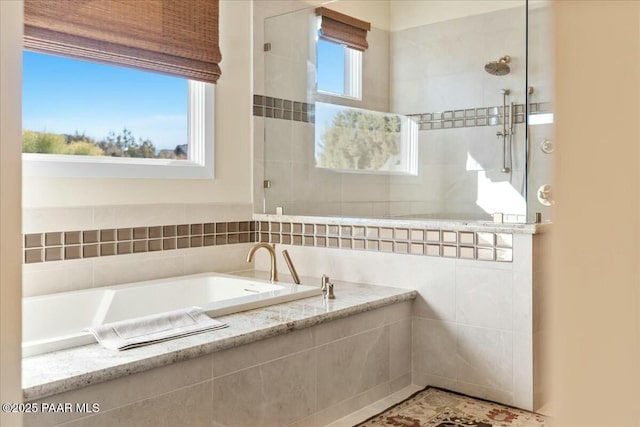 bathroom featuring separate shower and tub