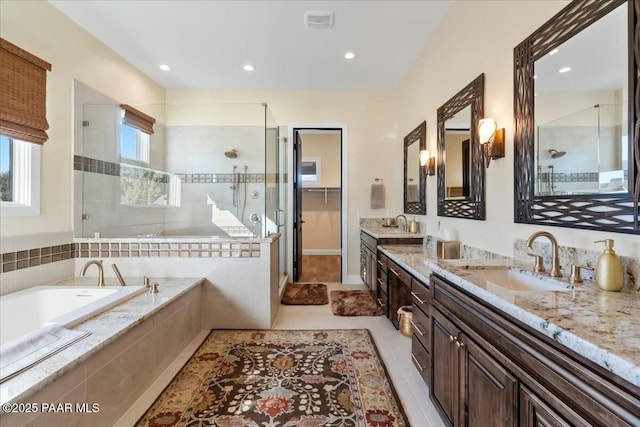 bathroom featuring tile patterned floors, separate shower and tub, and vanity