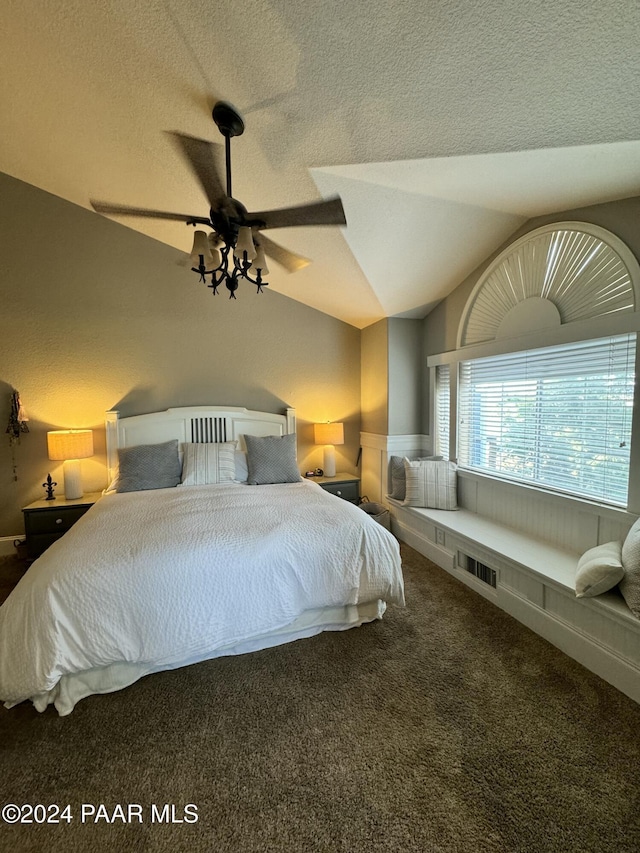 unfurnished bedroom with ceiling fan, lofted ceiling, carpet, and a textured ceiling