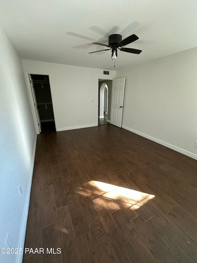 unfurnished room featuring ceiling fan and dark hardwood / wood-style floors