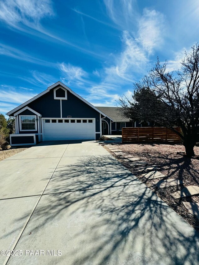 view of front of home featuring a garage and a patio area