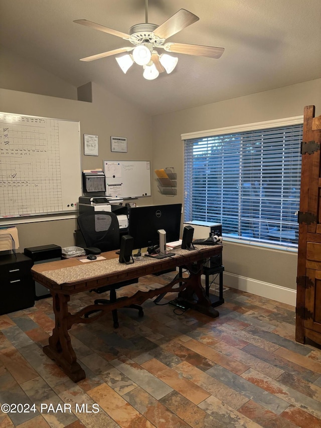 home office featuring vaulted ceiling and ceiling fan